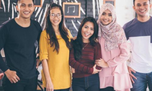 Young Malaysians hanging out in a coffee shop together  